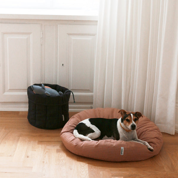 classic storage basket with dog toys in it